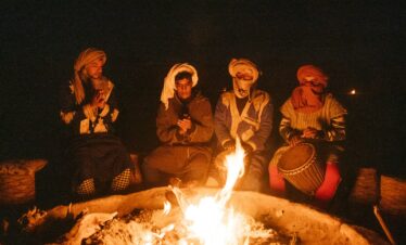 group of people sitting on chair in front of bonfire