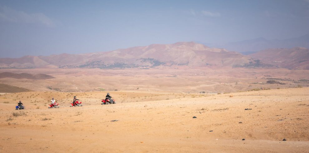 Group of quad bikers exploring the vast Agafay desert near Marrakech, Morocco.