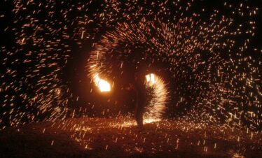 A mesmerizing fire dancer creates dazzling light patterns in Agafay Desert, Morocco.