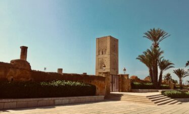 brown concrete building near green trees during daytime