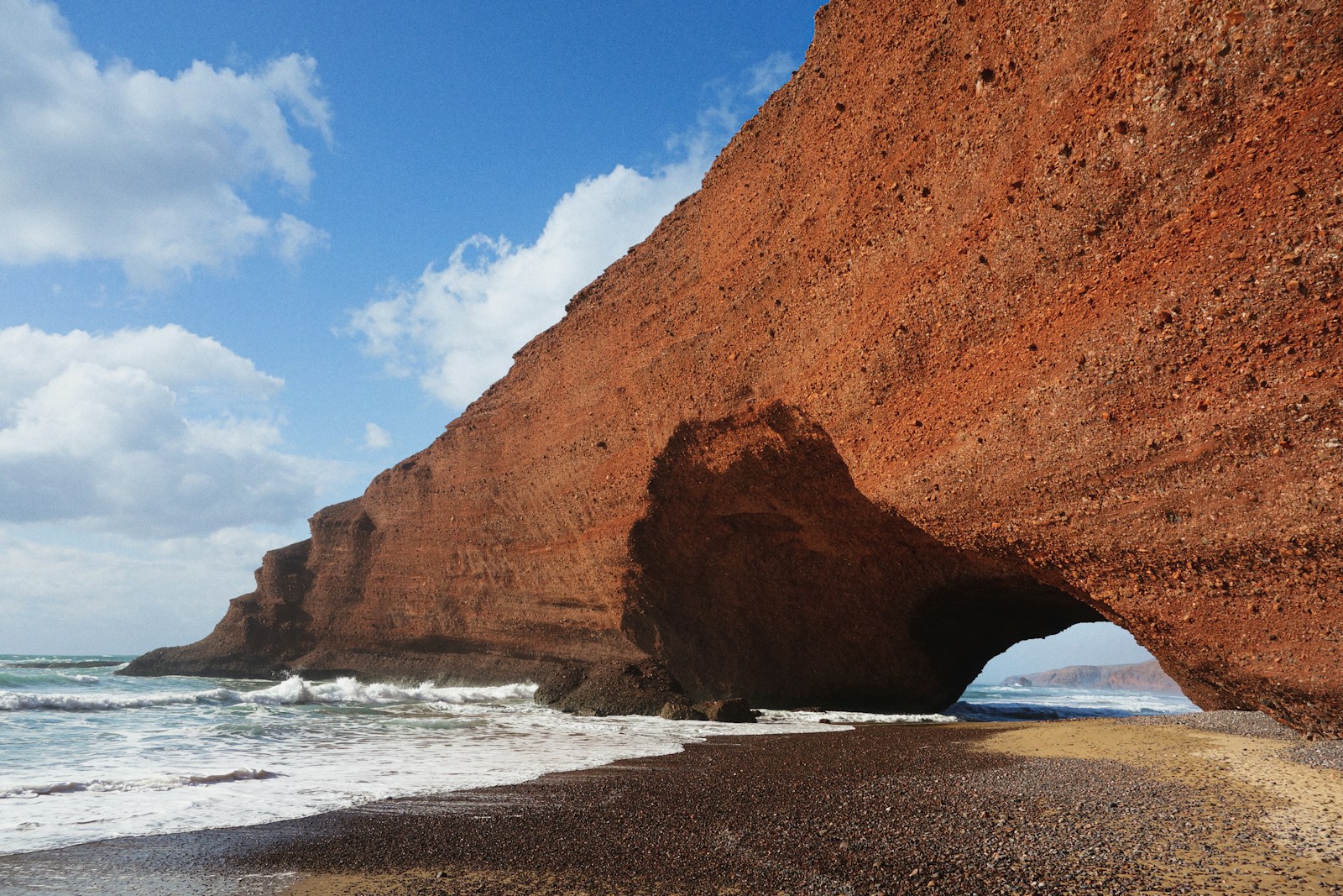 brown rock formation on sea shore during daytime