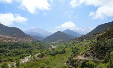 a valley with mountains in the background