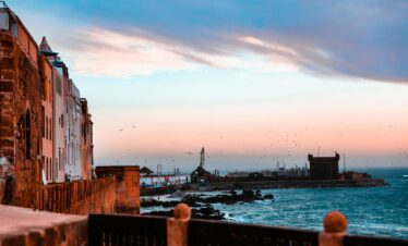 people walking on bridge near body of water during daytime