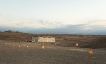 a desert area with several lit candles in the middle of it